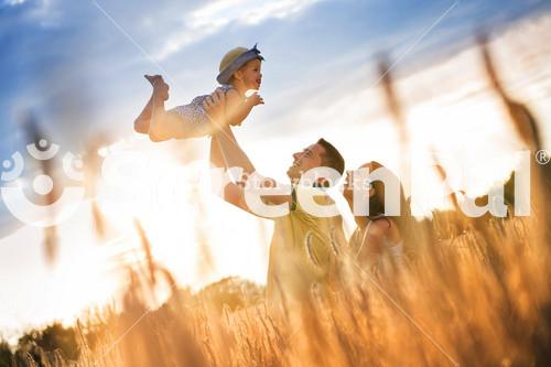 Joyful Family Enjoying Time Together In Sunny Field